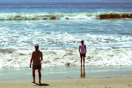 friends standing on the beachの写真素材