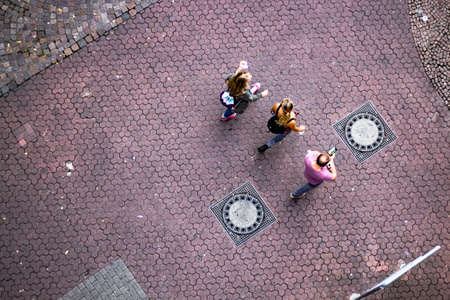 bird view of friends walking on the side walkの写真素材