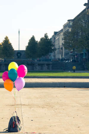Colorful helium balloons and backpackの写真素材