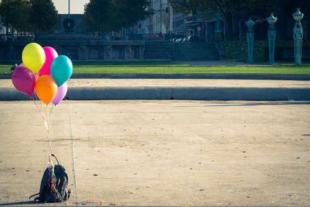 Colorful helium balloons and backpackの写真素材