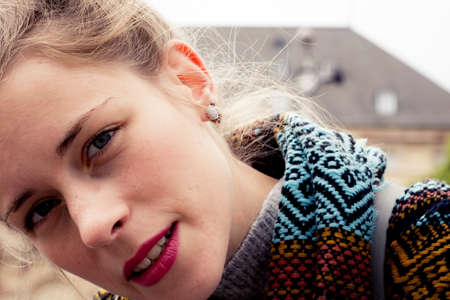 Young woman in cold weather wearing a scarfの写真素材