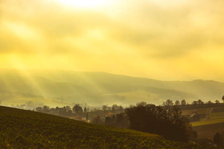Beautiful scenic sunrise with scattered clouds over hilly rural landscape in Lower Austria