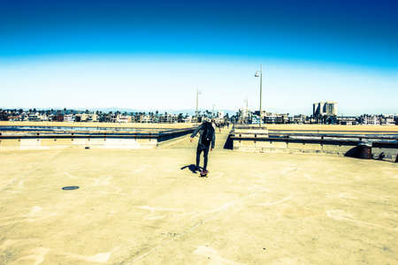 longboard skater in california by the oceanの写真素材