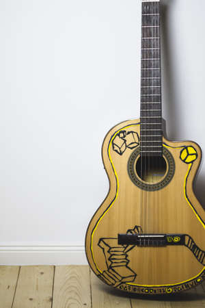 acoustic guitar on hardwood floor