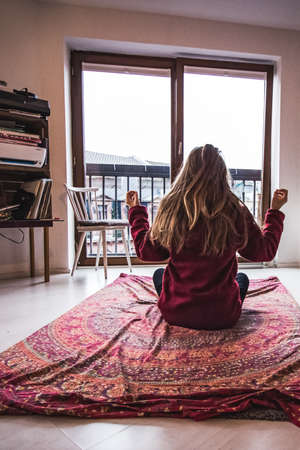 girl doing meditation exercises at homeの写真素材