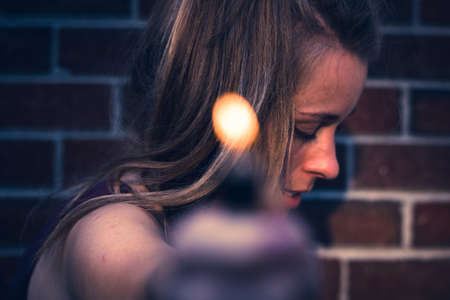 woman holding a lighterの写真素材