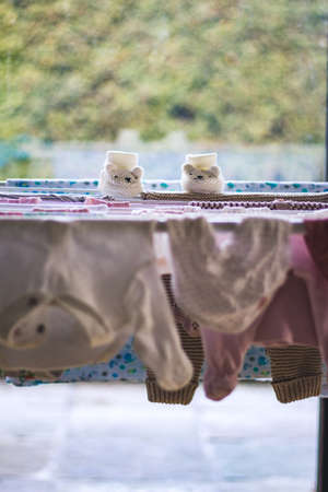 baby laundry hanging on a line-dryingの写真素材
