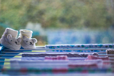 baby laundry hanging on a line-dryingの写真素材