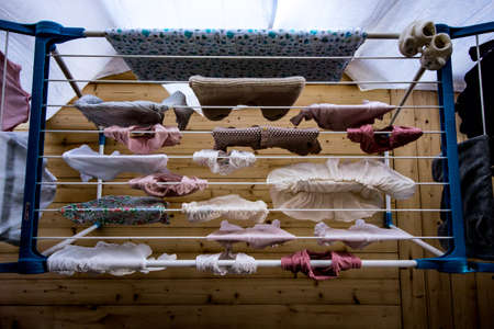 baby laundry hanging on a line-dryingの写真素材