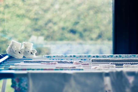 baby laundry hanging on a line-dryingの写真素材