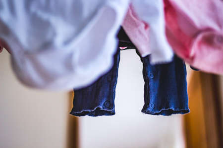 baby laundry hanging on a line-dryingの写真素材
