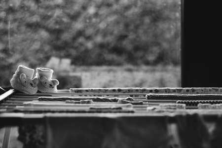 Baby laundry hanging on a line-dryingの写真素材