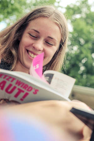 young woman reading a magazineの写真素材