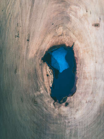 knothole in cherrywood filled with cast resinの写真素材