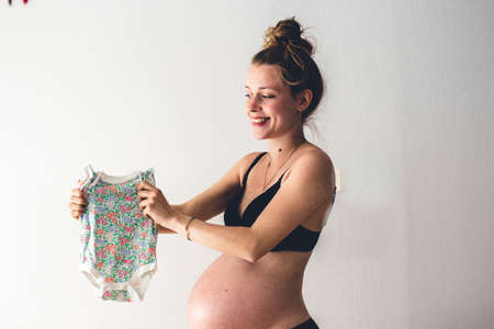 pregnant woman holding baby fashionの写真素材