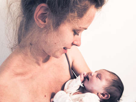 beautiful young mother holding her newborn baby in her arms