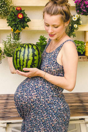 beautiful pregnant  young woman holding water melon