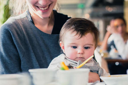 young mother having brunch with her babyの写真素材