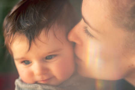 mother and baby portrait with refraction of lightの写真素材