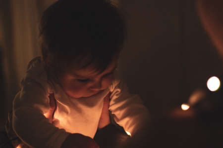 illuminated baby in the darkの写真素材