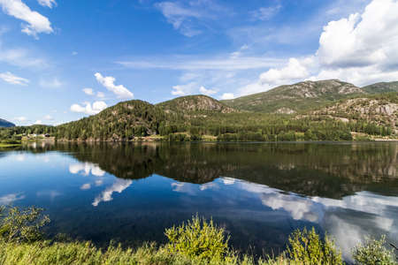 Norway mountains reflected in the clear fjordの写真素材