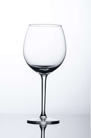 Wine glass on the reflection surfaceの写真素材