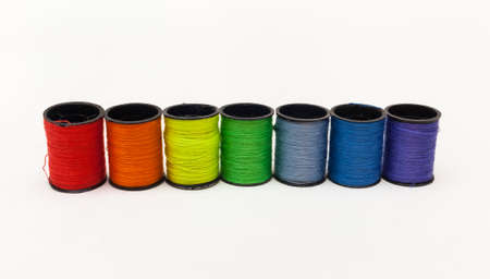 A set of colored yarn rainbow on a white background