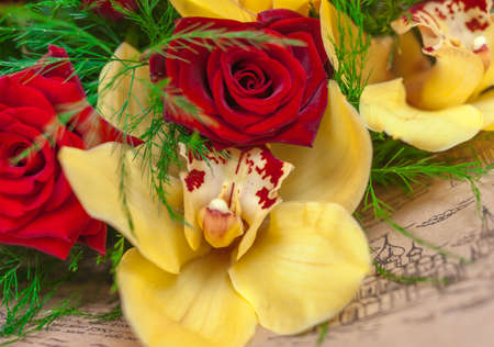 Bouquet of red roses and yellow orchidsの写真素材
