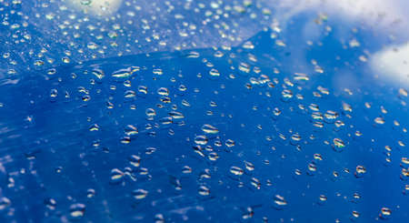 Rain drops on a blue backgroundの写真素材