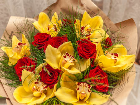 Bouquet of red roses and yellow orchidsの写真素材