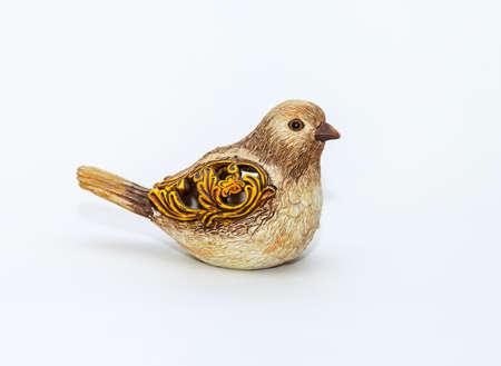 Brown ceramic bird toy with patterns on wingsの写真素材