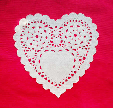 White doily hearts on red backgroundの写真素材