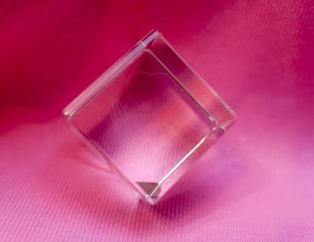 Transparent glass cube on a pink backgroundの写真素材