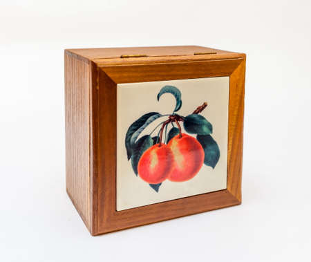 Wooden box with ceramic inlay on a white backgroundの写真素材