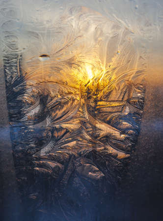 Frosty pattern on glass in the setting sunの写真素材