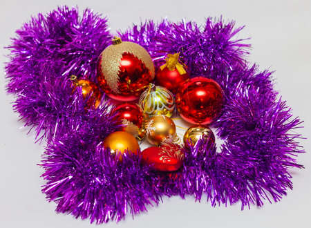 Red and gold Christmas balls with purple tinselの写真素材