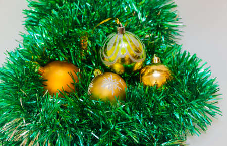 Golden Christmas balls with green tinselの写真素材