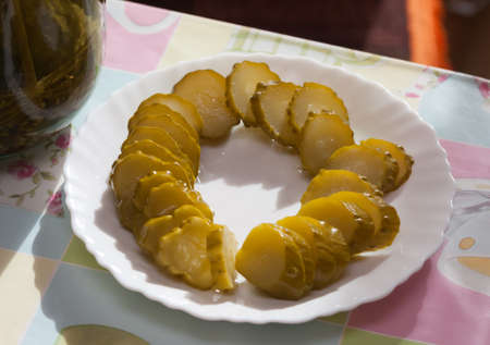 Pickles sliced on a white plate on the tableの写真素材