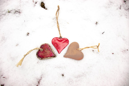 red reflective heart, red hearts in white snowの写真素材