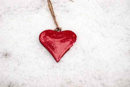 red reflective heart, red hearts in white snowの写真素材