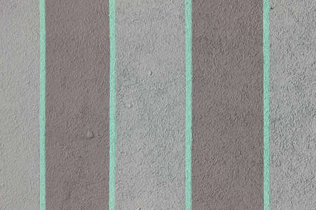 Turquoise stripes paint concrete wall surface. Painted cement structure.