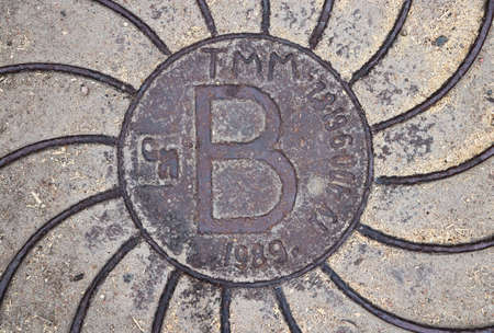 Rust metal hatchway with big B letter. Urban city street art.の写真素材