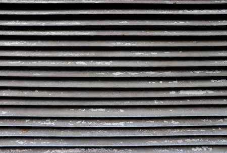 Metal weathered paint on gratings. Air street steel jalousie.