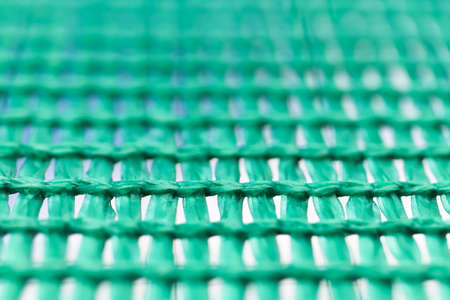 Green wired net surface with blurred background. Advertising backdrop.の写真素材