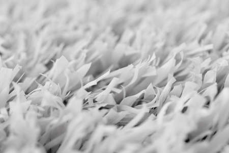 White artificial grass texture with blurred background. Modern soft tender monochrome backdrop. Exterior interior material.の写真素材
