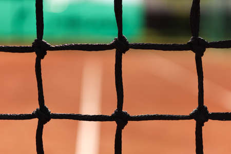 Focused tennis net with blurred background on the court. Sport backdropの写真素材