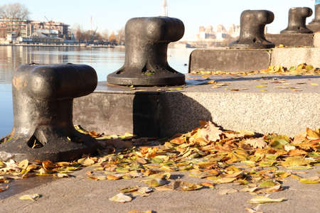 Ship Bollards on Granite Steps with Autumn Leaves. Saint-Petersburg.の写真素材