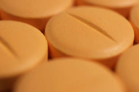 Orange Medicine Tablets. Pharmacy Pills Background. Macro Closeup.の写真素材