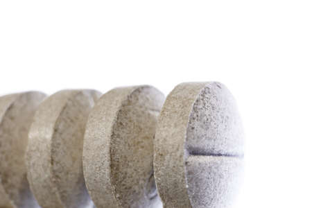 Gray Medicine Tablets Row. Pharmacy Pills on Lighted Background. Macro Closeup.の写真素材