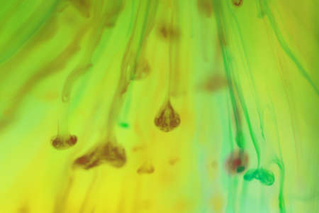 Colored Ink Drops Falling in Water. Abstraction Background.の写真素材